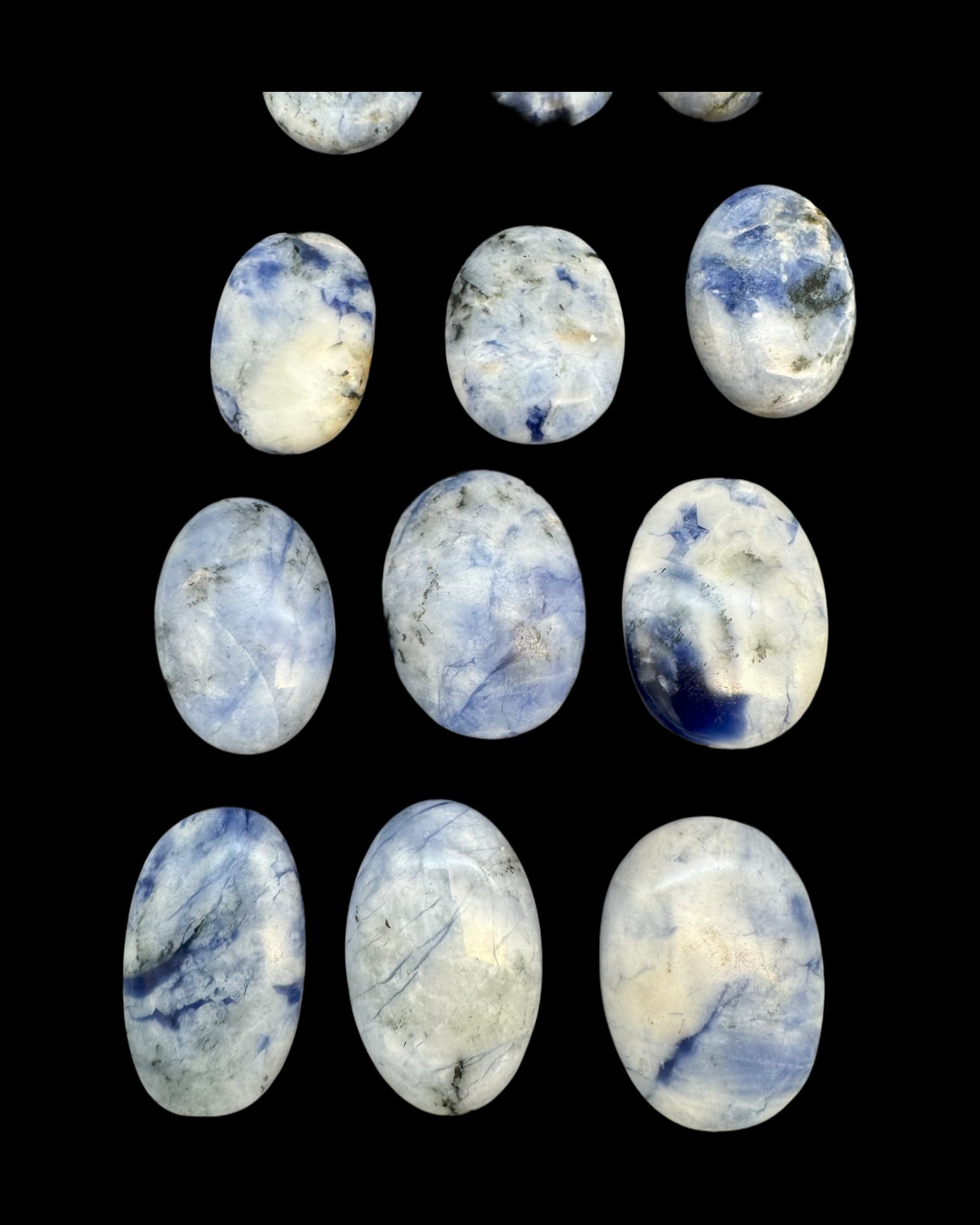 mehrere Sodalit Handschmeichler vor schwarzem Hintergrund